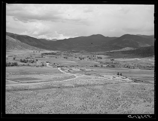 Untitled photo, possibly related to: The valley of the Rio Costilla at Amalia, New Mexico. The irrigated farmland is in the center with the grazing land surrounding
