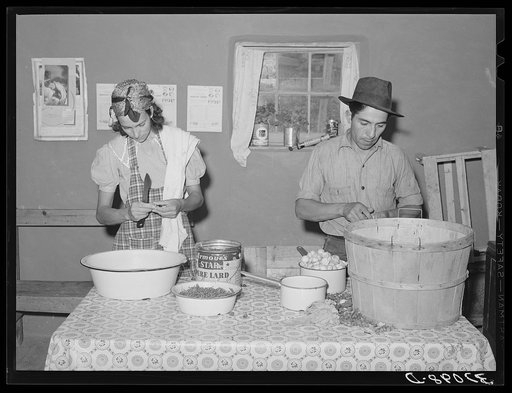 Spanish-American couple preparing fruit for canning. Chamisal, New Mexico