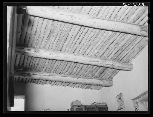 Vigas in Spanish-American home. This is regular ceiling construction on adobe houses. Amalia, New Mexico