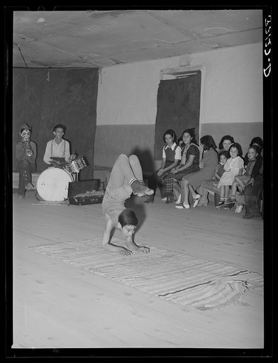 Acrobat and audience at Spanish-American traveling show. Penasco, New Mexico