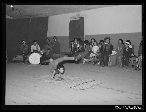 Acrobat and audience at Spanish-American traveling show. Penasco, New Mexico
