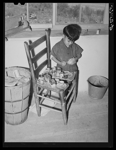 Spanish-American boy playing. Amalia, New Mexico