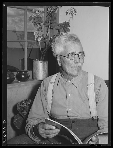Old Spanish-American man in his home at Chamisal, New Mexico
