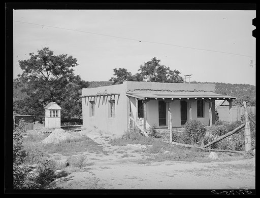 Adobe house and covered well. Penasco, New Mexico