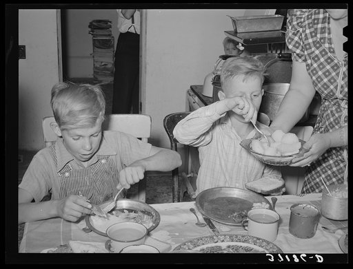 Children of Mormon farmer at dinner. Box Elder County, Utah