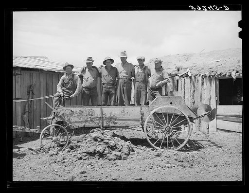Members of FSA (Farm Security Administration) cooperative manure spreader. Box Elder County, Utah