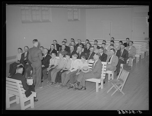 Meeting of the priesthood in Mormon church. This meeting is held on the first Sunday of every month and includes all males fourteen years of age and older. On this morning these men do without breakfast and give the saved money to the Bishop's fund. Mendon, Utah