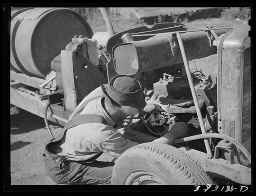 Untitled photo, possibly related to: Pouring gasoline into tank of converted automobile which supplies power for FSA (Farm Security Administration) cooperative orchard sprayer. Cache County, Utah