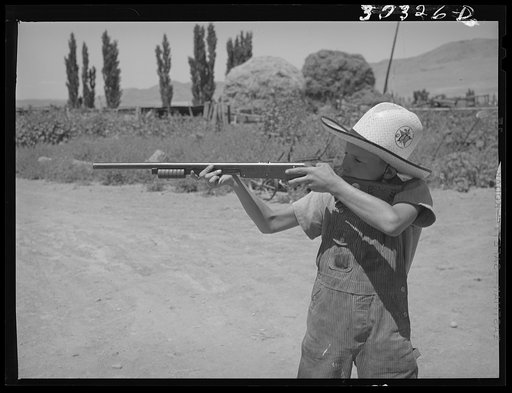 Mormon farm boy shooting air rifle. Box Elder County, Utah