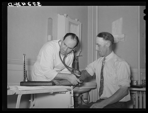 Doctor of FSA (Farm Security Administration) medical cooperative taking blood pressure of FSA rehabilitation borrower. Box Elder County, Utah
