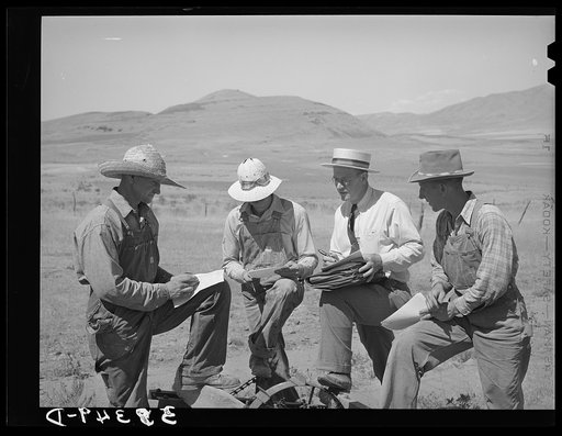Mr. Thayne, FSA (Farm Security Administration) cooperative specialist, signing up three Ericson brothers to buy a cooperative tractor. Box Elder County, Utah