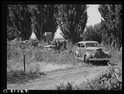 Working on jigs, with dormitories in the background at the FSA (Farm Security Administration) trailer camp for defense workers. The dormitories at this project will accommodate, when finished, 952 single men. Dormitory residents will pay five dollars weekly for single rooms and three dollars and fif