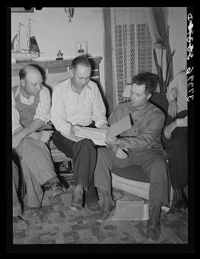 FSA (Farm Security Administration) county supervisor, center, looks over the books of the FSA cooperative stallion organization. Box Elder County, Utah