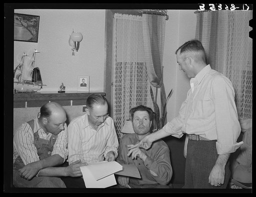 Member of FSA (Farm Security Administration) cooperative stallion association making payments to caretaker for stallion. Box Elder County, Utah