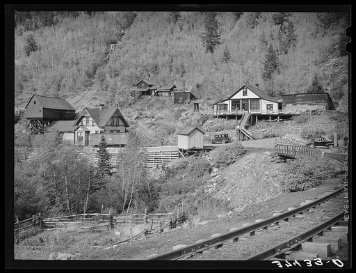 Railroad station and liquor store at Ophir, Colorado. A narrow gauge railway runs into the town with supplies and takes out the ore