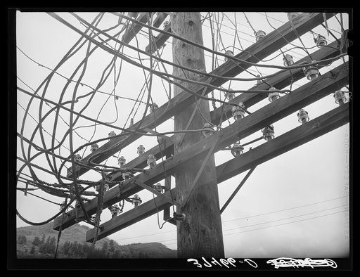 State of disrepair of electical wiring shows the slowdown of mining operation and consequent disintegration of a town. Telluride, Colorado