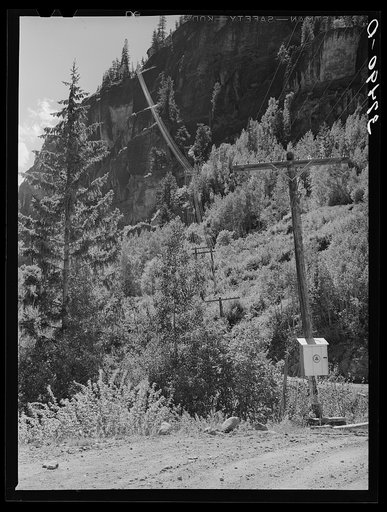 Telephone wires stretched up a mountainside on road. Camp Bird Mine, Ouray County, Colorado