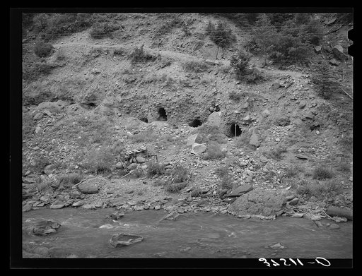 Tunnels dug into the sides of the banks of the San Miquel River in search for gold. San Miquel County, Colorado