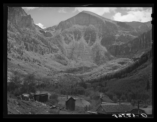 Untitled photo, possibly related to: End of mountain valley near Telluride, Colorado, showing road up to mine and Bridal Veil Falls