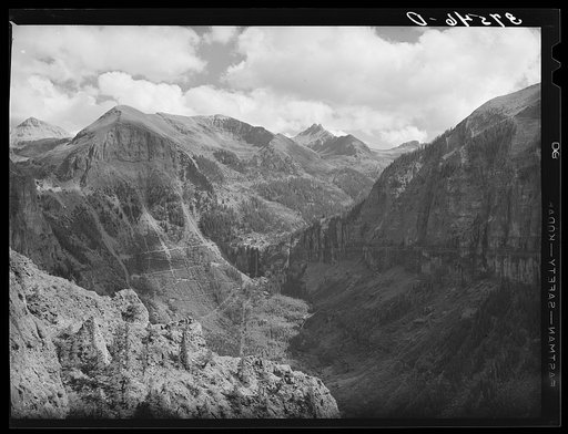 Mountain valley near Telluride, Colorado, showing road up the mountain, Bridal Veil Falls, timberline and the mountain peaks