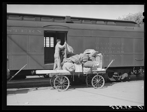 Taking off the mail at the morning train. Montrose, Colorado