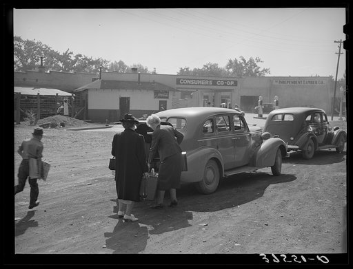 Loading baggage of train passenger into automobile. Montrose, Colorado