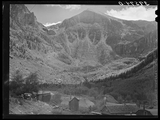 End of mountain valley near Telluride, Colorado, showing road up to mine and Bridal Veil Falls