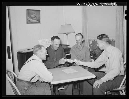FSA (Farm Security Administration) supervisor handing check to chairman of committee for purchase of cooperative ensilage harvester. Cornish, Utah