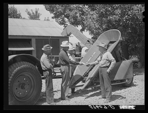 Chairman of Cornish machinery cooperative handing over check to dealer in payment of ensilage harvester. Preston, Idaho