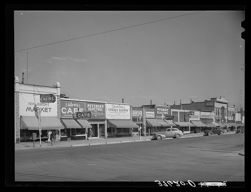 Main street of Brigham, Utah. In the small shopping centers in the Mormon communities the business establishments are likely to be many small ones rather than one large company dominating