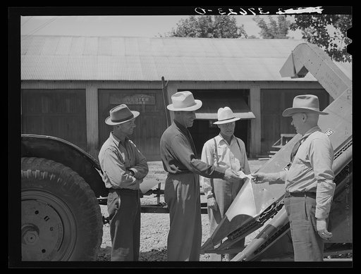 Untitled photo, possibly related to: Chairman of Cornish machinery cooperative handing over check to dealer in payment of ensilage harvester. Preston, Idaho