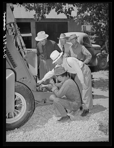 Committee of the Cornish corn machinery cooperative receiving instructions from the mechanic concerning the ensilage harvester which the cooperative bought. Preston, Idaho