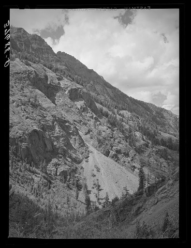 Slide in mountains in Ouray County, Colorado. Land and snow slides both are frequent in this area and imperil mines and miners