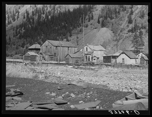 Backyards of buildings on the main street of the ghost town of Eureka, Colorado. Notice the waste dumps on mountainside, which will identify this as a mining town