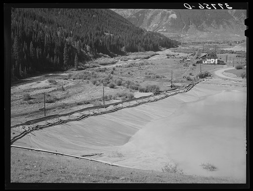 Tailing pit of active gold mine in the valley of the Animas River, San Juan County, Colorado. Ranchers and farmers who want to use water for irrigation in the lower valley have always attempted to force the mine and mill operators to keep the tailings from polluting the streams; however, without muc