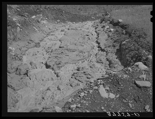 Stream of tailings from large active gold mill in San Juan County, Colorado