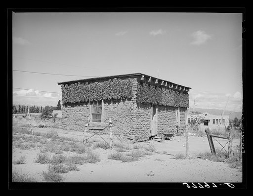 Chile peppers drying on adobe house. Concho, Arizona
