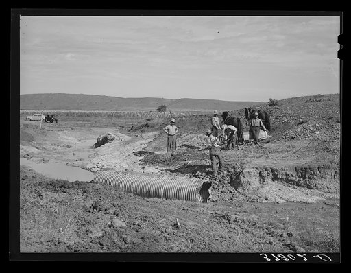 Men of Concho, Arizona, building a bridge across stream