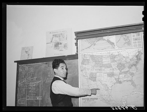 School teacher in grade school teaching geography. Concho, Arizona