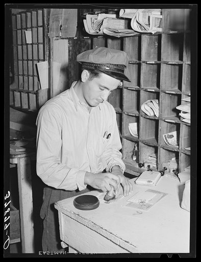 Postmaster cancelling stamps. Concho, Arizona