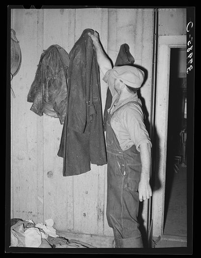 John Frost, farmer in Tehama County, California, donning his work overcoat