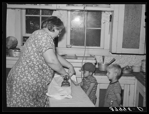 Mrs. J. Webster ironing while her sons look on. Tehama County, California