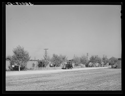 Houses for married couples fashioned from old boxcars. Earl Fruit Company ranch. Kern County, California