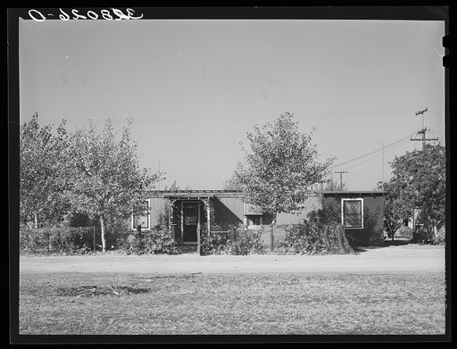 Home of married couple working on Earl Fruit Company ranch. Kern County, California. These houses have been made from boxcars
