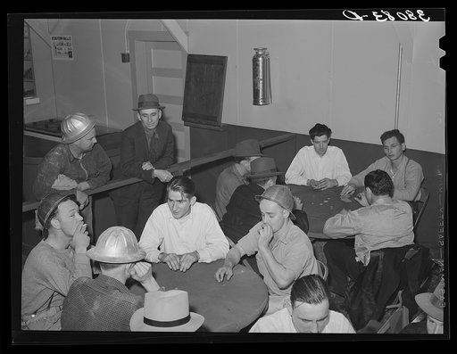 Construction workers at Shasta Dam playing cards at construction canteen. Shasta County, California