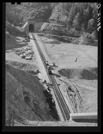 Many miles of the Southern Pacific railroad had to be enrouted and new tunnels and track constructed to take care of impounding of water by Shasta Dam. Shasta County, California