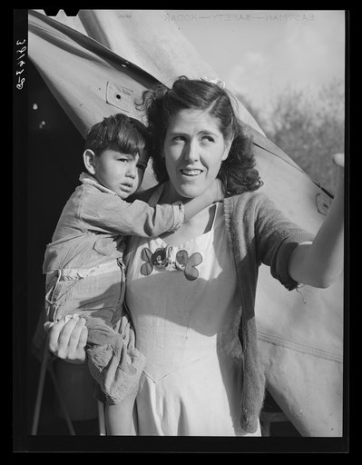 Mother and child in front of tent-home. This family is from Oregon. The man is a concrete worker. Mission Valley, California, which is about three miles from San Diego