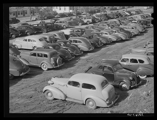 Workers' automobiles parked near the airplane factories. San Diego, California. Providing parking space for automobiles and getting the cars in and out at shift changing time have been big problems