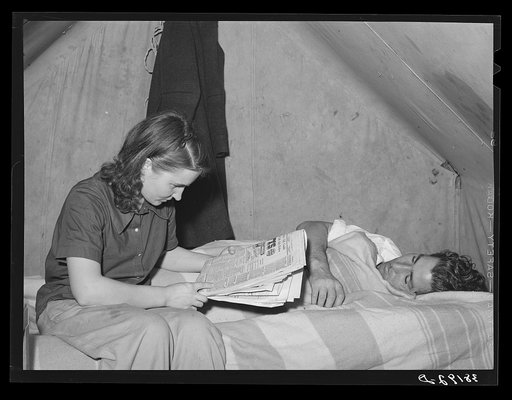 Concrete worker resting while his wife looks for apartments in the want ads. He works the night shift. They have been unable to find a reasonably priced apartment and are living in a tent. They are from Washington. Pacific Beach, California