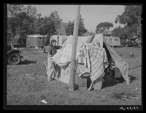 Concrete workman's wife drying out blankets that were wet during the rain the night before. Pacific Beach, California